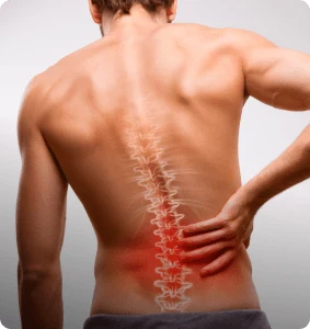 A man holds his lower back in pain