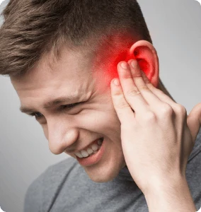 A man holding his ear, showing signs of pain